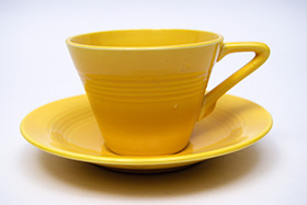 Vintage Harlequin Pottery Yellow Cup and Saucer Set For Sale
Vintage Harlequin Pottery Yellow Cup and Saucer Set For Sale