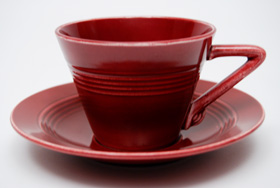 Vintage Harlequin Pottery Maroon Cup and Saucer Set For Sale
Vintage Harlequin Pottery Maroon Cup and Saucer Set For Sale