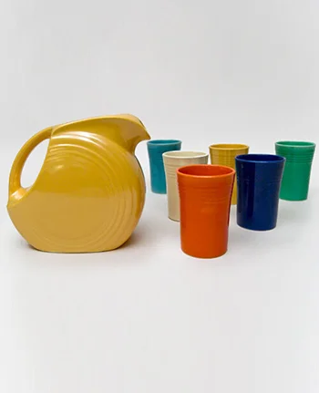 Vintage Fiestaware 7 Piece promotional Set with yellow juice pitcher and six tumblers in the original fiesta colors of red, blue, green, ivory, yellow and turquoise