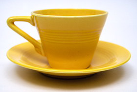 Vintage Harlequin Pottery Yellow Cup and Saucer Set For Sale